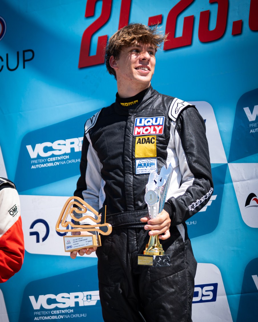 Nicolas Lenzi Loeffler on the podium with the winner&rsquo;s trophies